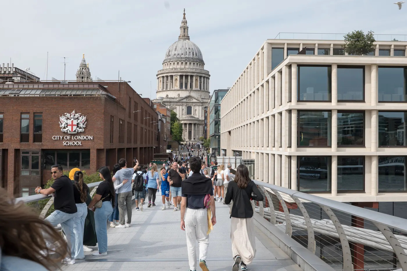 A small tour group shares a laugh with their guide in a hidden City of London passage